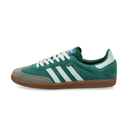 Adidas Samba OG Collegiate Green Gum Grey Toe.
Denne sneaker er perfekt til at skille sig ud på gaden. Den kommer i en smuk grøn farve og skiller sig bestemt ud fra mængden. Køb denne lækre sneaker her hos os.
set fra siden